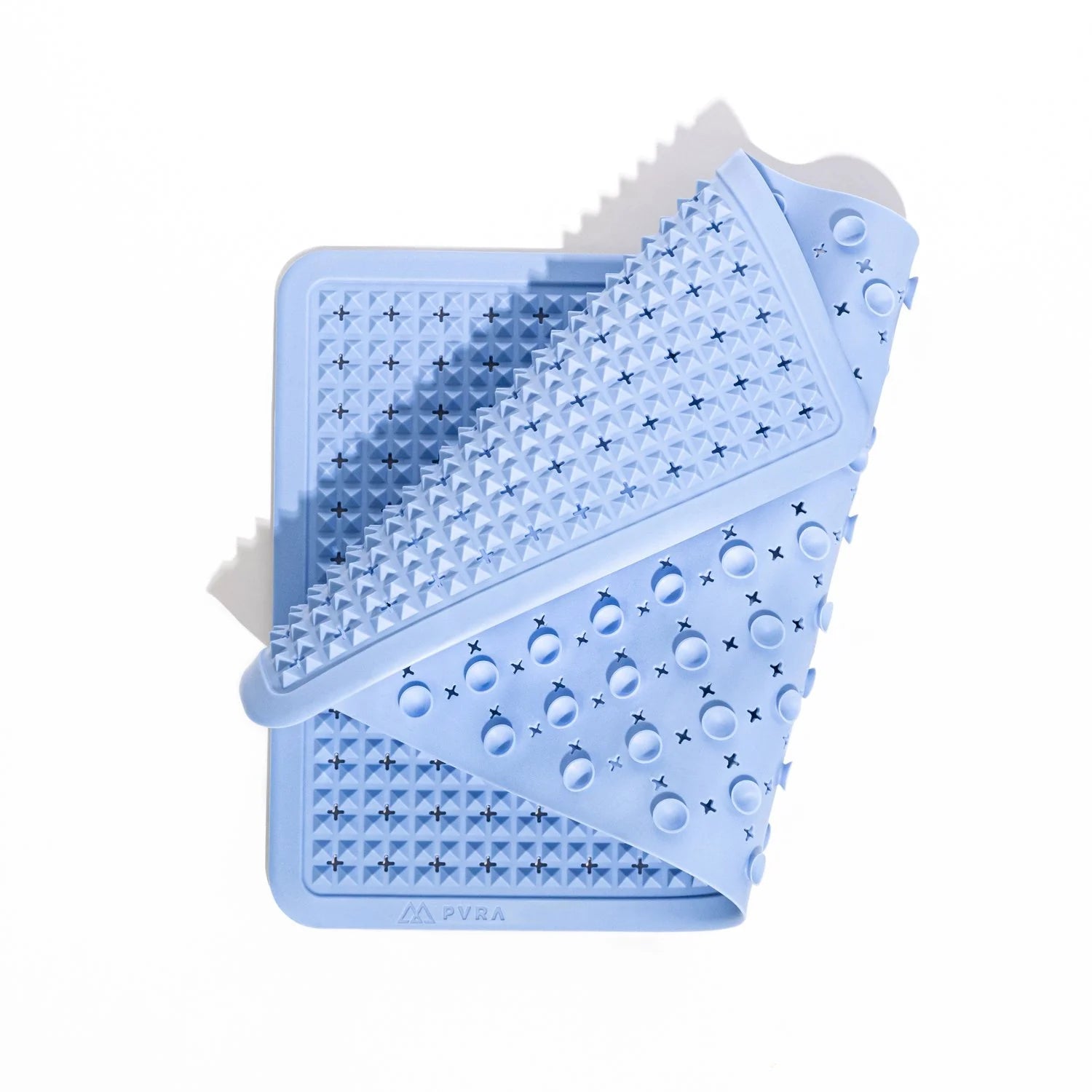 The blue PVRA acupressure mat, folded to show the spikes and suction cups